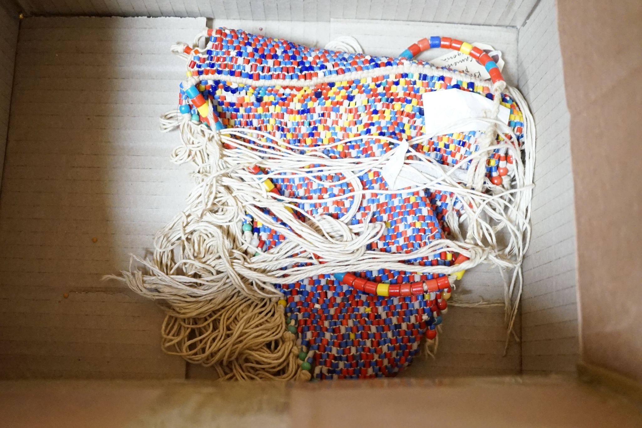 A large African beadwork necklace and three beadwork bags